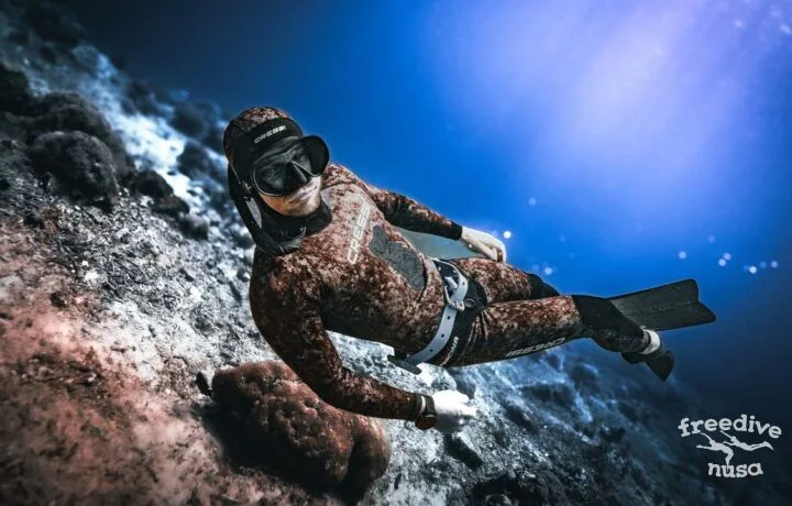 Freediver in rays of sun